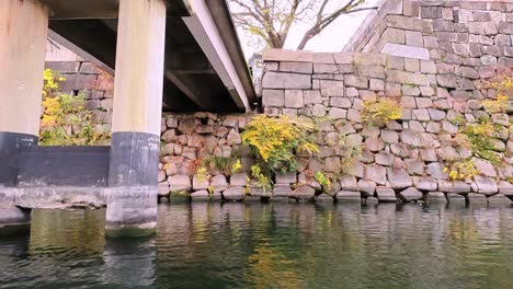 view from castle moat onto the famous osaka castle in japan