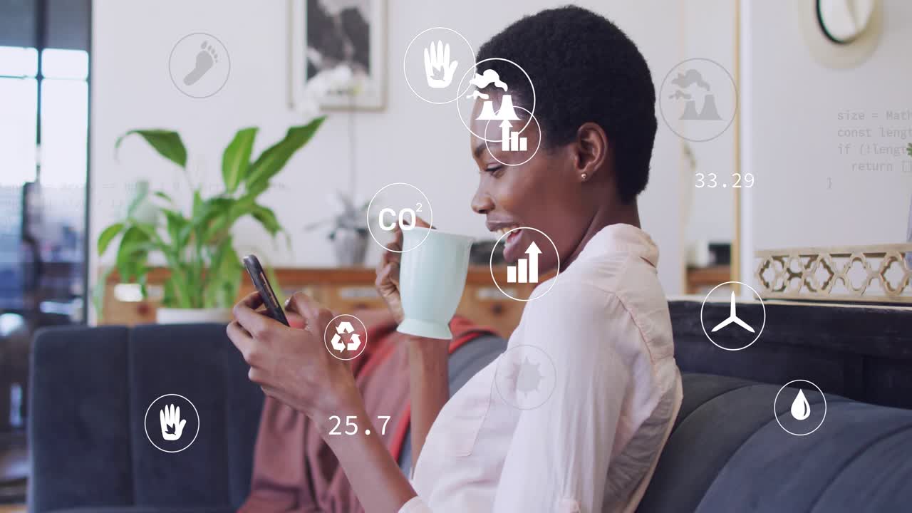 Woman on sofa scrolling, sipping mug, tapping phone and checking CO2 eco overlays updating numbers