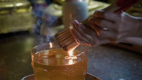 burning joss stick with a candle for prayer