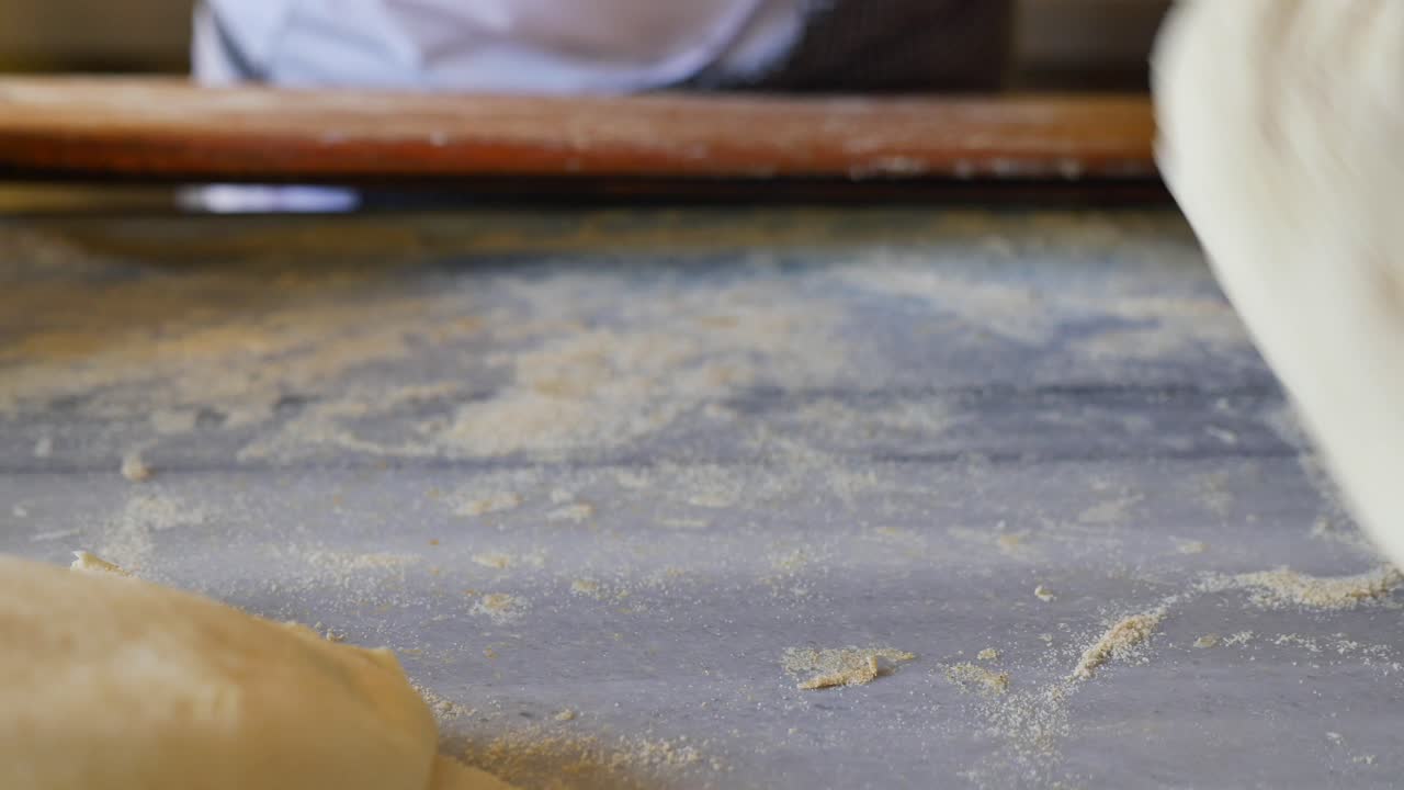 Hands Kneading and Shaping Fresh Dough for Baking