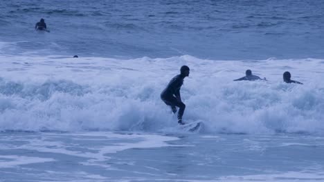 Slow-Motion-Of-Woman-Surfing-In-Sea-Against-Sky-During-cloudy-day,-Portugal