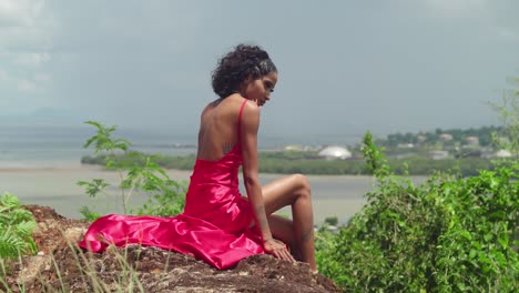 perched atop san fernando hill, a girl in a glamorous red dress takes in the sights of the city and the coastline.