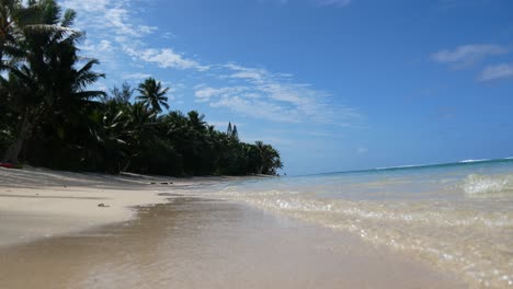 waves lapping the beach in rarotonga