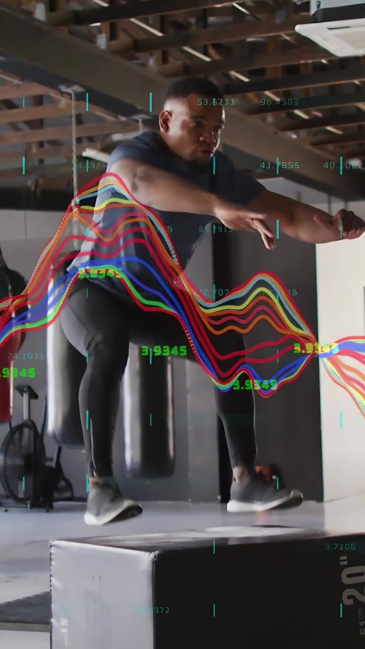 Vertical video: Man swinging arms, jumping on plyo box, training in gym, waveforms showing metrics