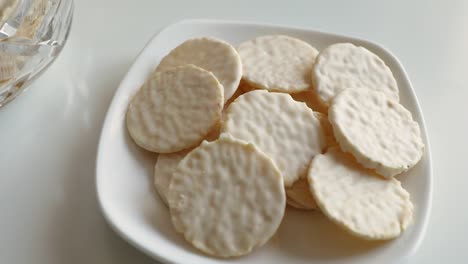 round cookies in white chocolate on a white table. sweet morning.