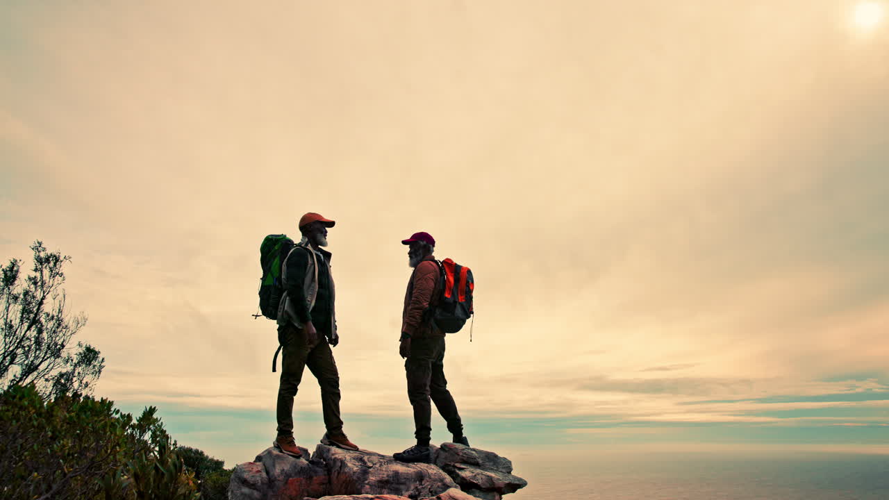 Two men hiking on a mountain with backpacks