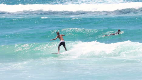 sequence of a surfer catching and riding a wave