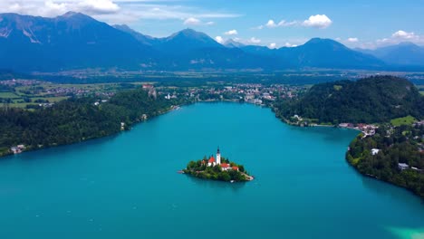 aerial 4k drone video of lake bled with lake bled island and alp mountains in the background - slovenia