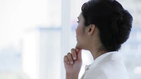 businesswoman standing in office and looking at the camera seriously