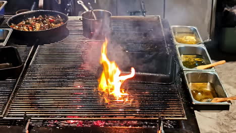 professional cook grilling chickens in skewers inside kitchen.