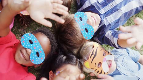 Happy-friends-gesturing-while-lying-on-grass-4k