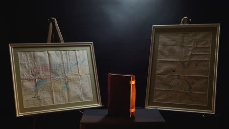 historical maps and a leather-bound book