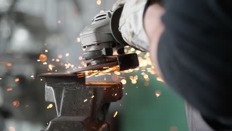 a man working with angle grinder, sparkles, super slow motion, close up