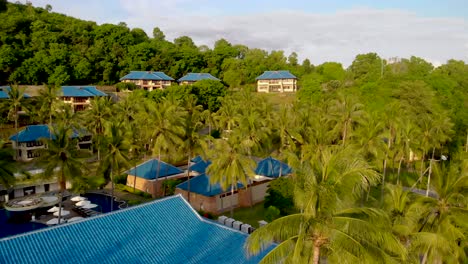 Aerial-liftoff-over-luxury-resort-on-the-coast-of-Lombok,-Indonesia