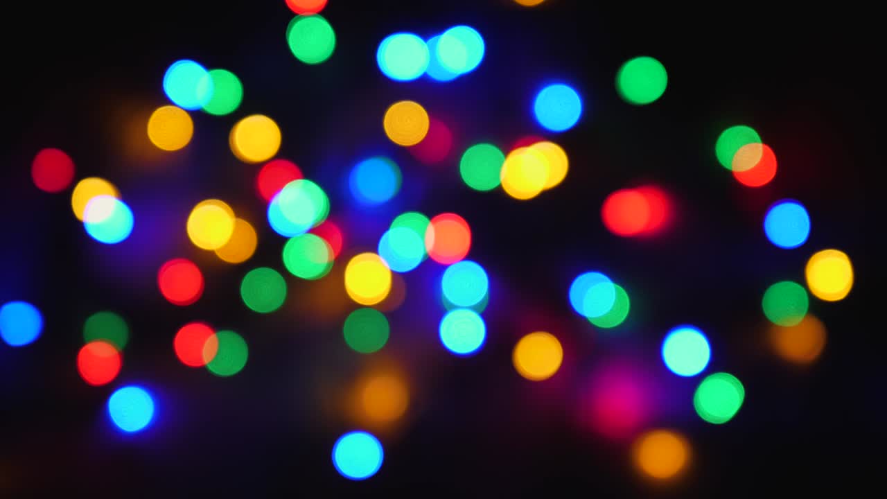 Blurred Twinkling Multi-Colored Holiday Lights On Black Background