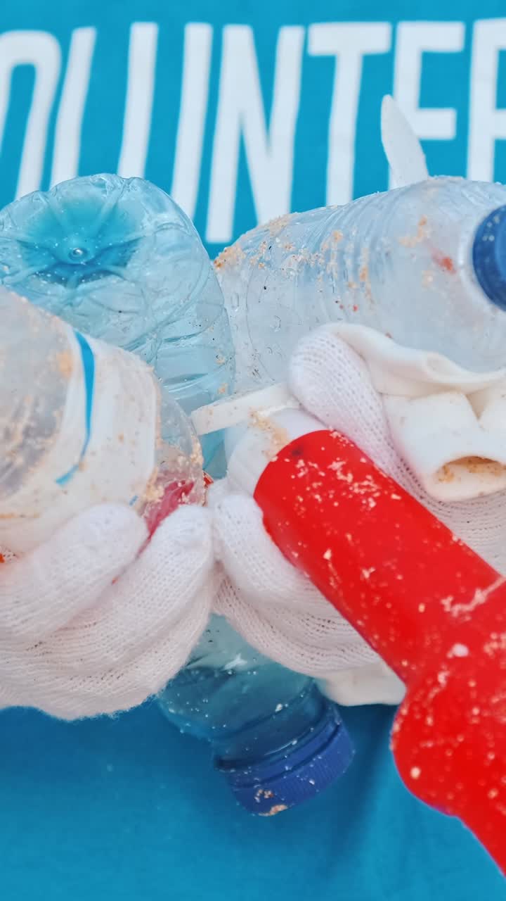 Plastic trash in hands of volunteer trying to draw attention to eco problems