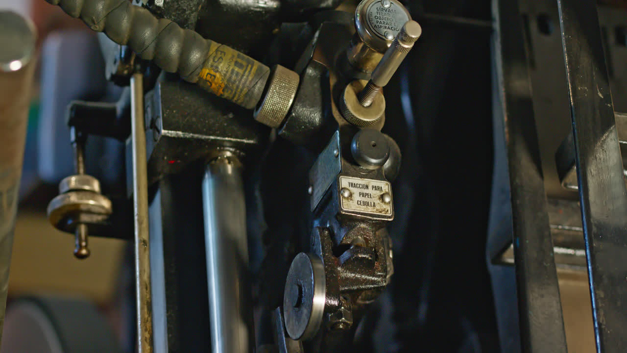 Close-up of Vintage Industrial Printing Press Mechanism in Operation