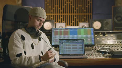 young caucasian man working at music recording studio