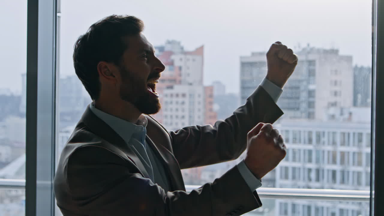 Cheerful founder celebrating contract raising arms in cityscape hallway closeup
