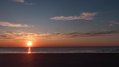 time lapse shot  of sunset above calm waves at a beach, on langeoog island, in north germany