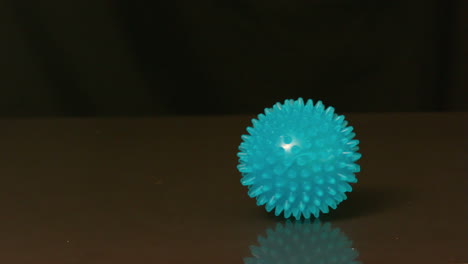 massage ball spinning across black surface