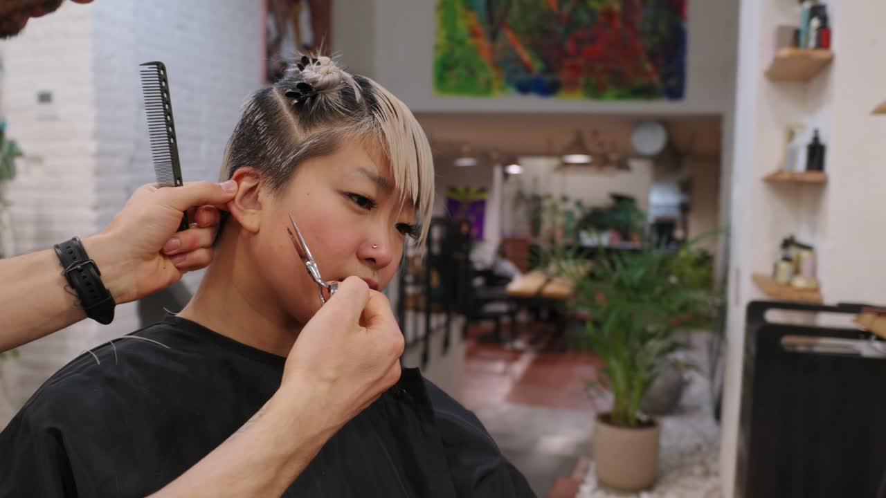 A woman getting a haircut at a hair salon