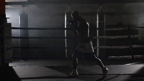 male boxer training in boxing ring