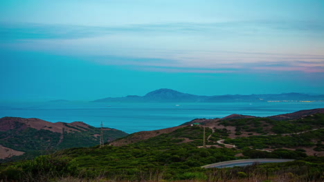 algeciras harbor view timelapse during twilight blue hour over scenic landscape in the foreground on a hilltop in spain