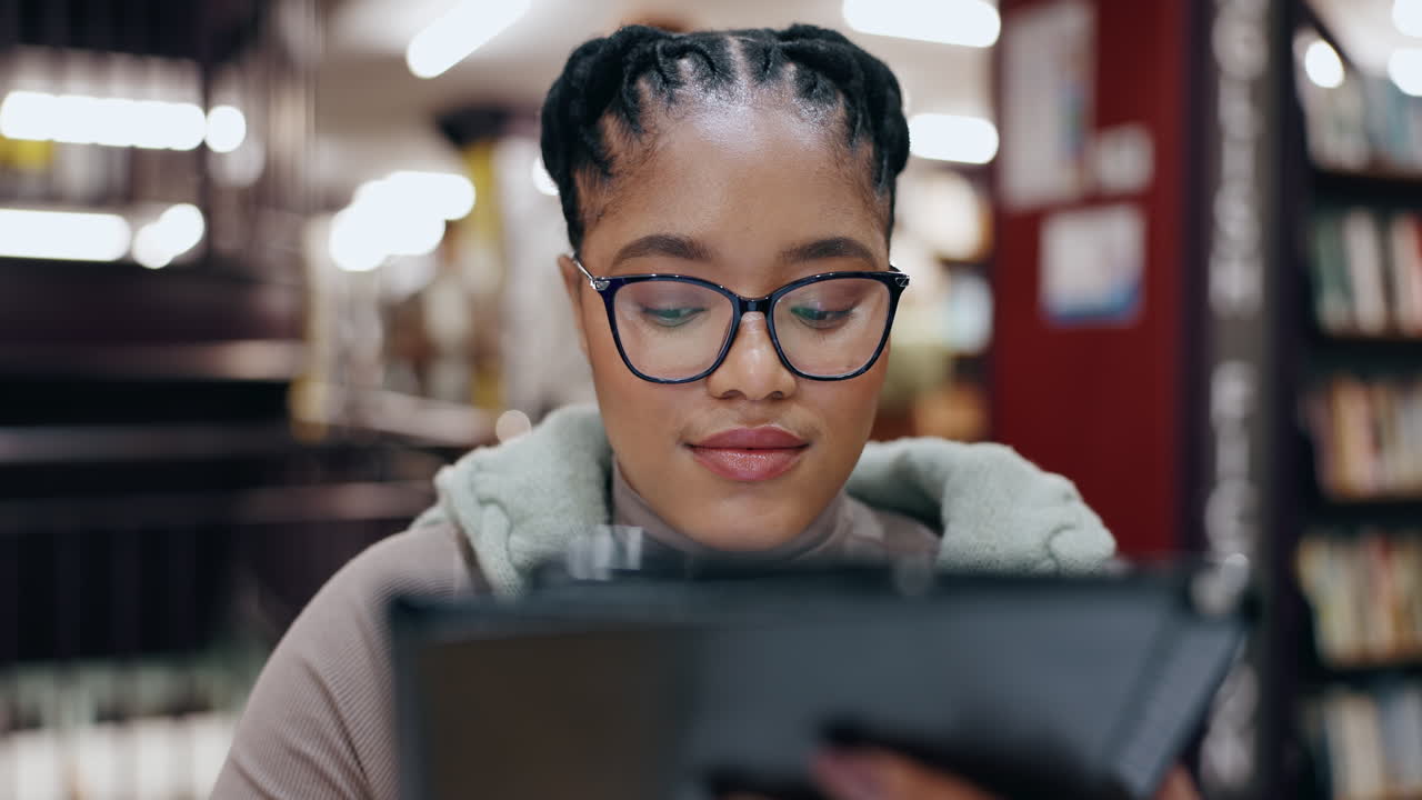 Woman using tablet in a library
