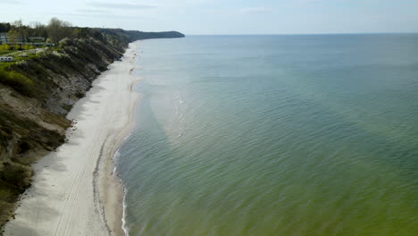 beautiful aerial shot along white sand beach on baltic sea in poland