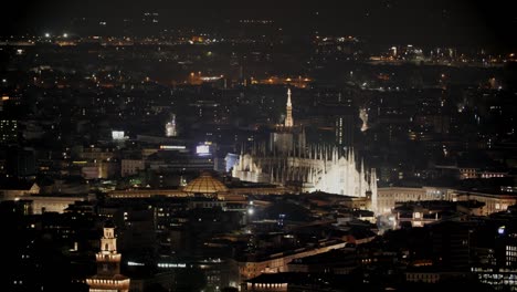 milan duomo and gallery glowing at night, aerial view