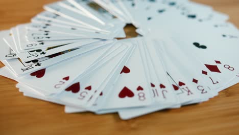 close interior static shot of piles of cards all open on a spinner