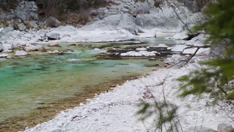 Beautiful-view-of-turquoise-water-going-down-the-river-at-Soca-river,-Slovenia