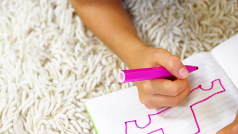 Lying-kid-drawing-on-the-floor