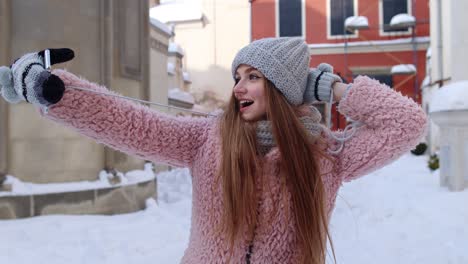 Woman-blogger-making-selfies-photo-pictures-for-social-networks-on-mobile-phone-on-city-street