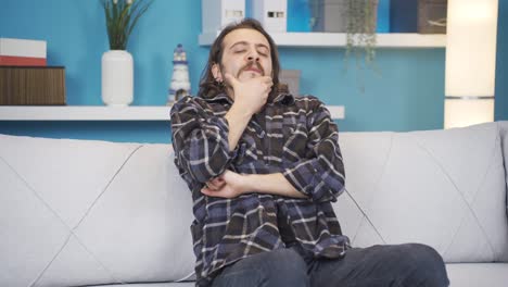 the man rubbing his face from nervousness.