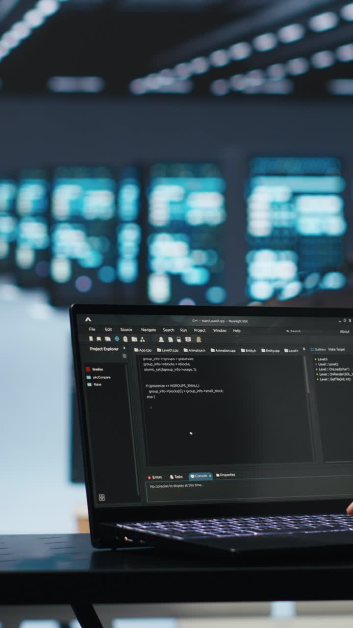 Developer Typing Code on Laptop in High-Tech Office