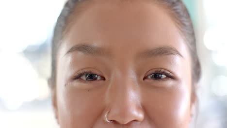 smiling teenager with nose ring, close-up of face, happy expression