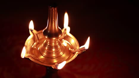 traditional south indian brass oil lamp 'nilavilakku '. during events like housewarming, marriage etc., the nilavilakku is lighted before starting the rituals. this video is taken during a wedding