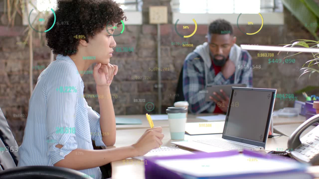 Woman sitting writing notes laptop readout driving HUDs guiding notes man analyzing business data