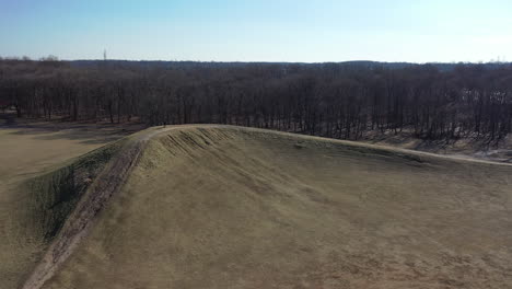 an aerial shot over an open field on a sunny day