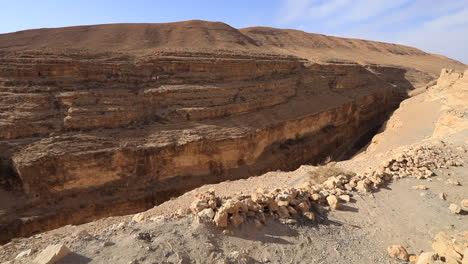 sunlit mides canyon in tunisia with rugged cliffs and clear blue sky, no people