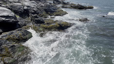 Aerial-video-of-rocky-coast-with-waves-crashing-Jamestown,-RI