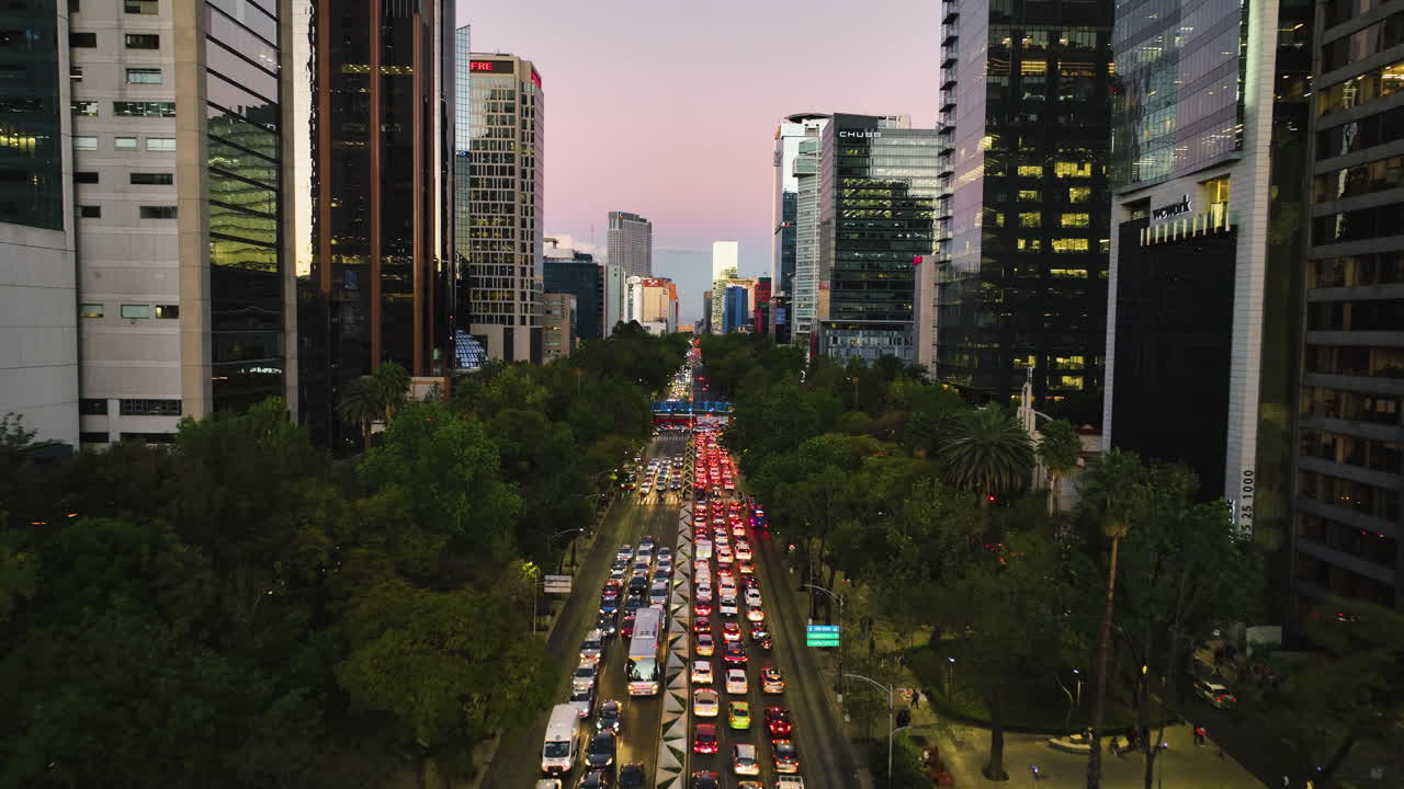 Drone flyover traffic on the Reforma Avenue, colorful evening in Mexico city