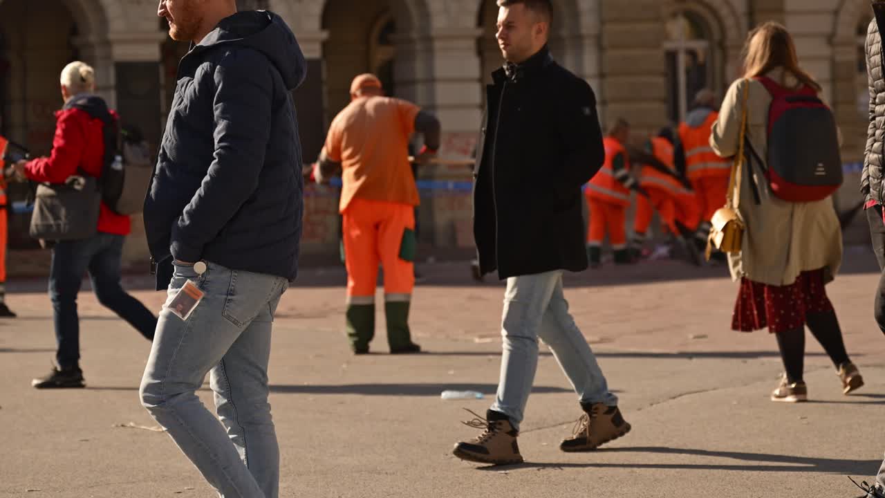 Street sweeper cleaning Town hall building and square after protest over fatal rail