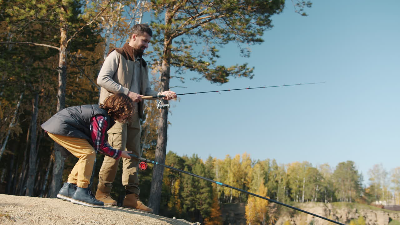Father and Son Fishing in Autumn Forest