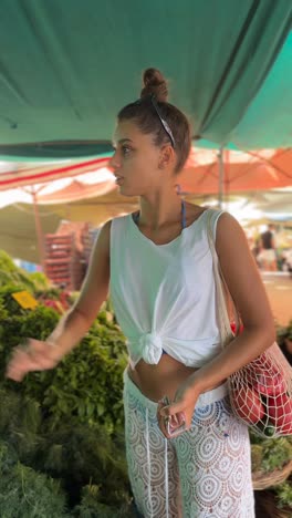 woman shopping for vegetables at a market