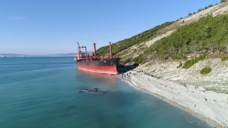 abandoned cargo ship on a rocky beach