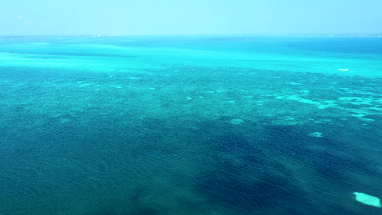 Aerial over turquoise blue waters of the Caribbean Sea, near Cancun's hotel zone