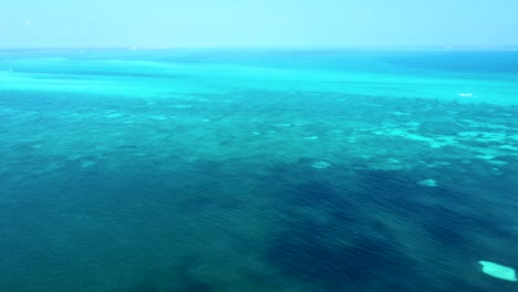 aerial over turquoise blue waters of the caribbean sea, near cancun's hotel zone